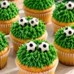 Festive Vanilla Soccer Cupcakes with Vibrant Emerald Grass Frosting and Sugar Ball Armor